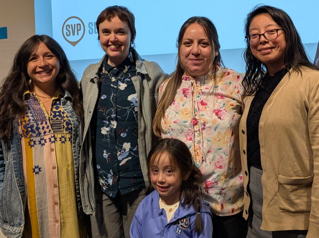 Four women and one child posing for a photo