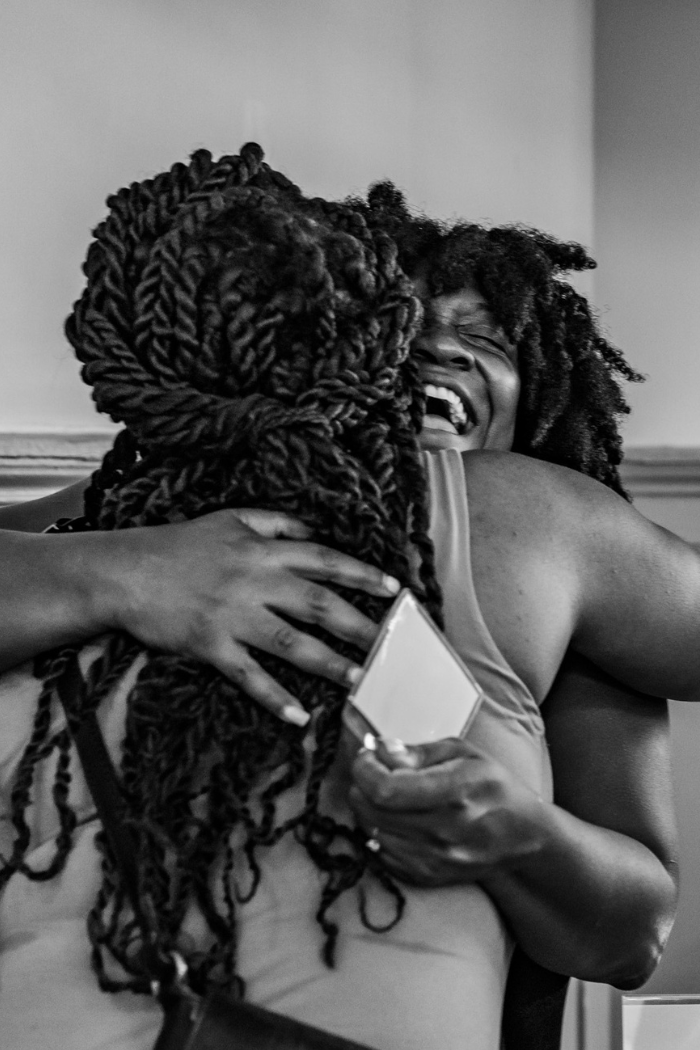 Two attendees embrace in a joyful hug during GrowFundMe: Thrive, celebrating connection and community after the event.